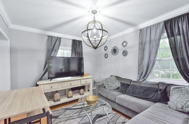 living room with crown molding, wood finished floors, and a chandelier