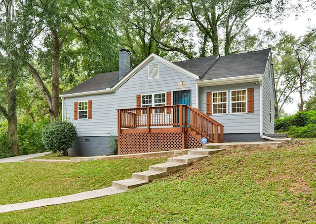 back of property featuring a wooden deck, crawl space, a shingled roof, a yard, and a chimney
