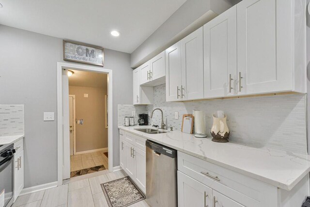 kitchen with a sink, decorative backsplash, baseboards, dishwasher, and white cabinets