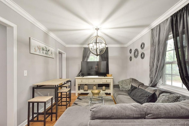 living area featuring baseboards, wood finished floors, an inviting chandelier, and crown molding