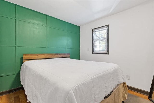 bedroom with dark hardwood / wood-style flooring