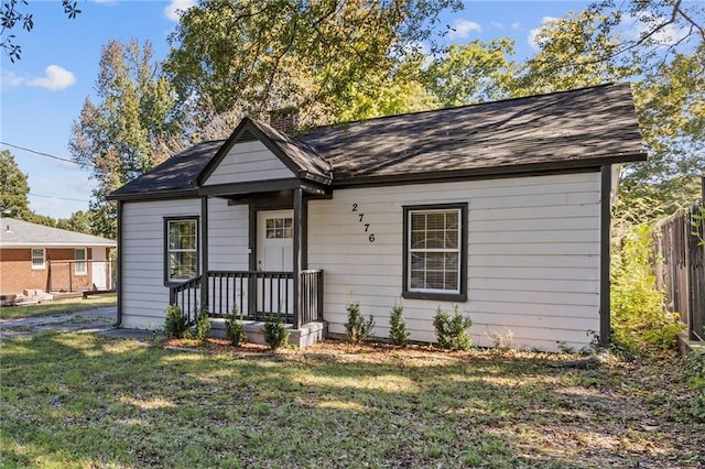 bungalow-style house featuring a front yard