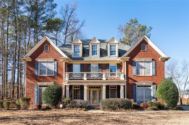 view of front of home featuring a balcony