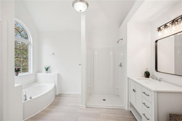 bathroom with vanity, lofted ceiling, and shower with separate bathtub