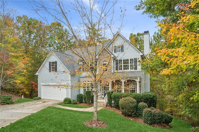 view of front of home with a front yard and a garage