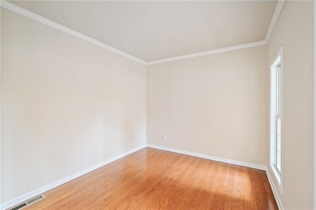 spare room with crown molding and wood-type flooring