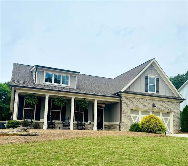 craftsman-style house with brick siding, a front lawn, board and batten siding, and covered porch