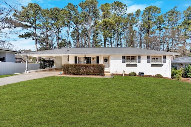 single story home with driveway, an attached carport, a front yard, and fence