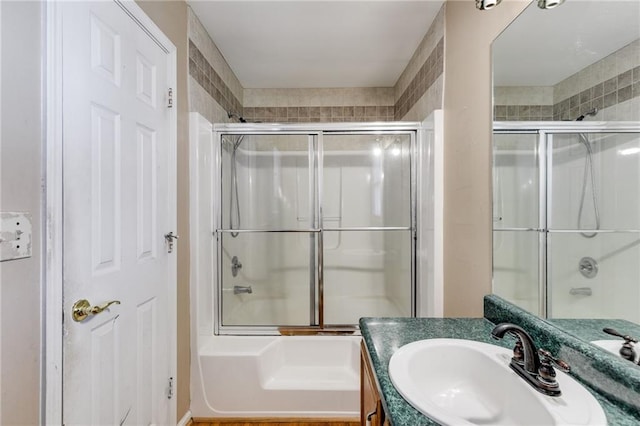 bathroom with vanity and bath / shower combo with glass door