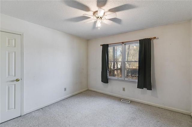 unfurnished room featuring ceiling fan and a textured ceiling