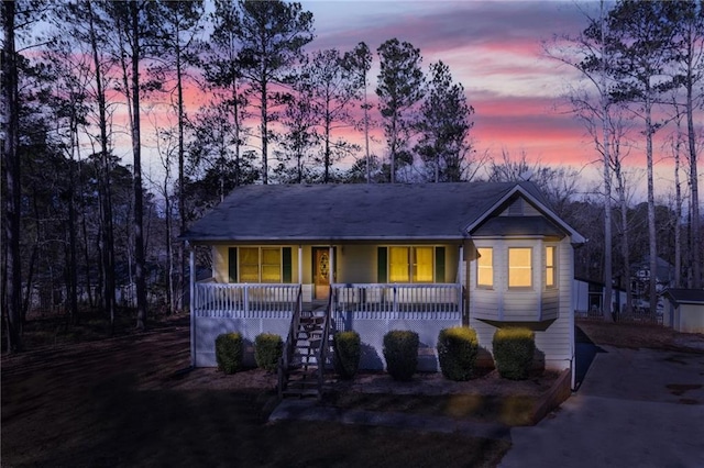 single story home featuring covered porch