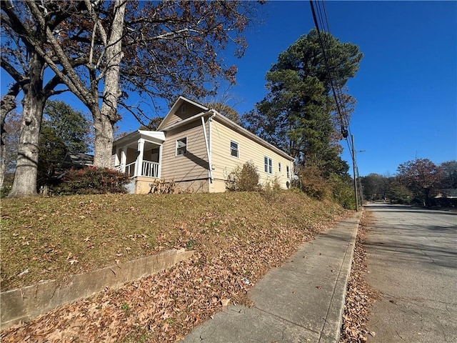 view of side of home featuring a porch