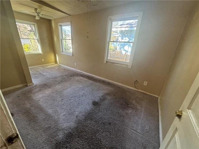 carpeted empty room featuring ceiling fan