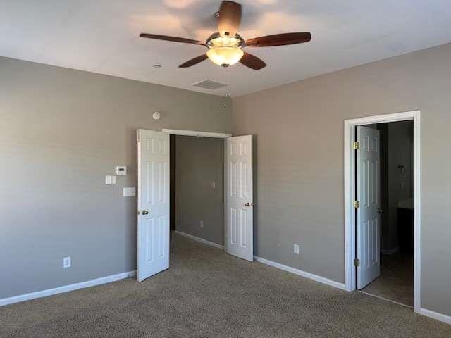 unfurnished bedroom with baseboards, visible vents, ceiling fan, and carpet