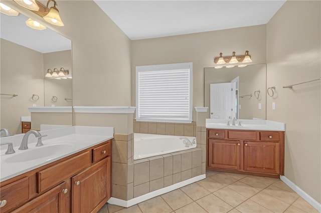 full bath with a sink, tile patterned floors, a bath, and two vanities