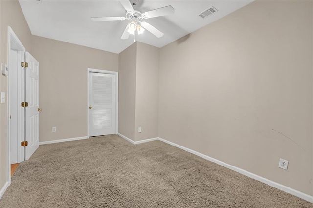 unfurnished bedroom with carpet, a ceiling fan, baseboards, visible vents, and a closet