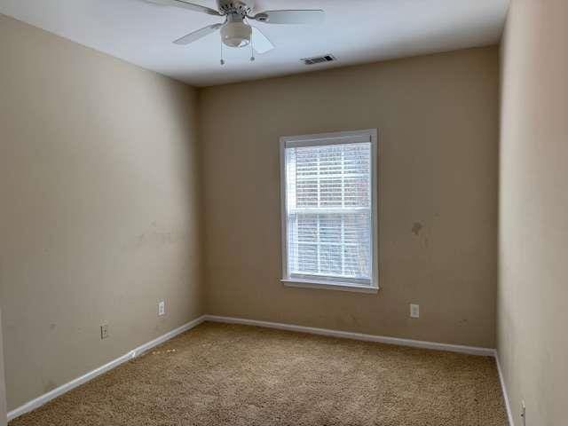 unfurnished room featuring visible vents, baseboards, and carpet floors