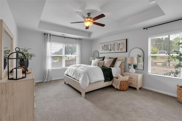 1311 Park Center Cir, Austell, GA 30168 - bedroom featuring a tray ceiling, light carpet, and ceiling fan