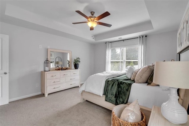 1311 Park Center Cir, Austell, GA 30168 - bedroom featuring a tray ceiling, light carpet, and a ceiling fan