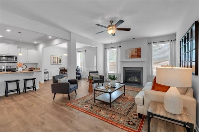 1311 Park Center Cir, Austell, GA 30168 - living room with plenty of natural light, ceiling fan, light wood-style flooring, a fireplace with flush hearth, and recessed lighting