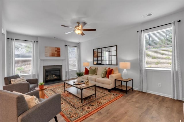 1311 Park Center Cir, Austell, GA 30168 - living room with plenty of natural light, ceiling fan, wood finished floors, and a fireplace with flush hearth