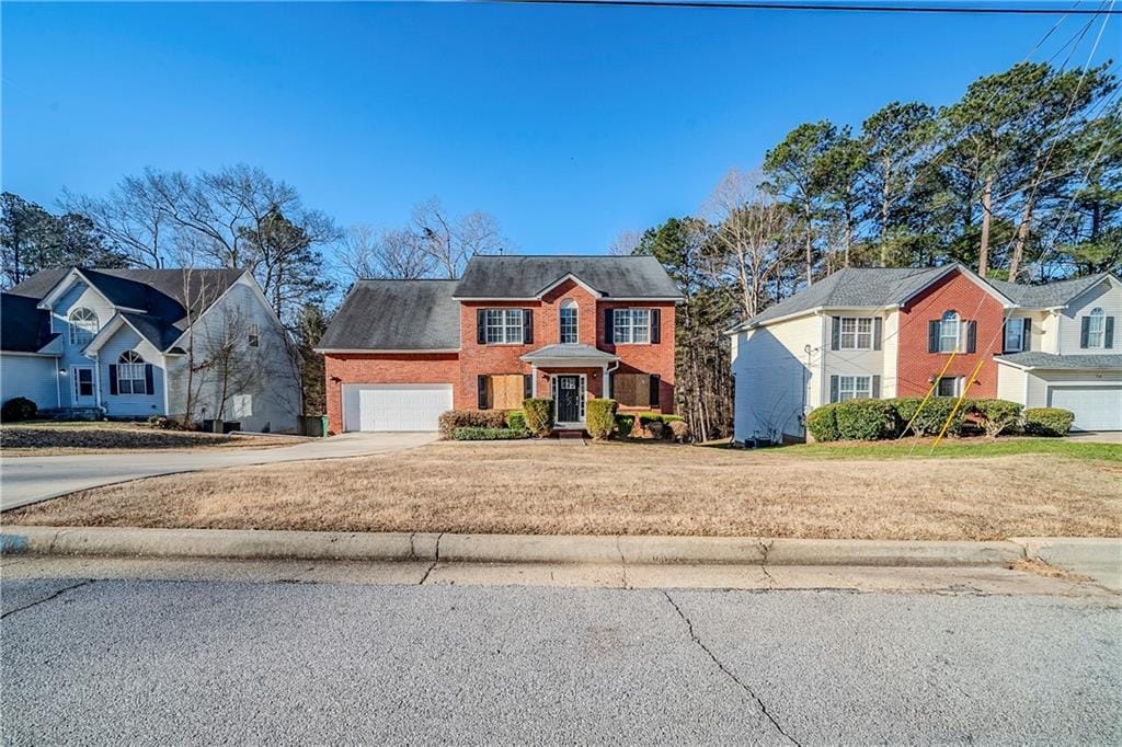 view of front of house featuring a garage and a front yard