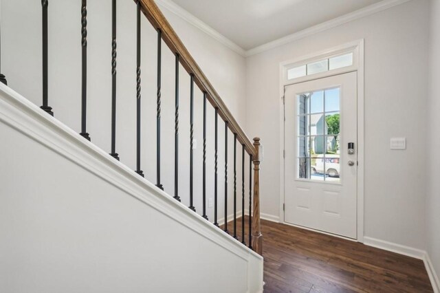 entryway with ornamental molding and dark hardwood / wood-style flooring