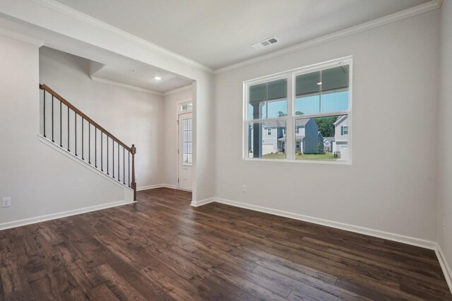 interior space with dark hardwood / wood-style flooring and ornamental molding