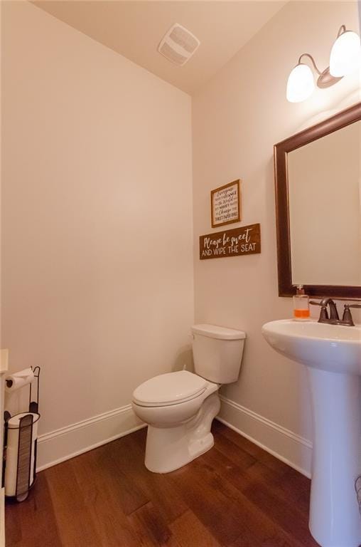6828 New Fern Ln, Flowery Branch, GA 30542 - half bathroom with wood finished floors and toilet