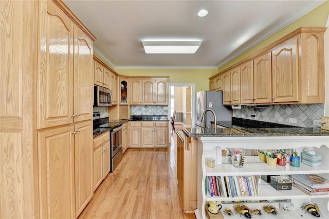 kitchen with dark stone counters, appliances with stainless steel finishes, crown molding, light wood-type flooring, and light brown cabinets