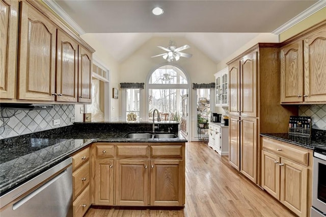 kitchen with light wood finished floors, dishwasher, lofted ceiling, a peninsula, and a sink