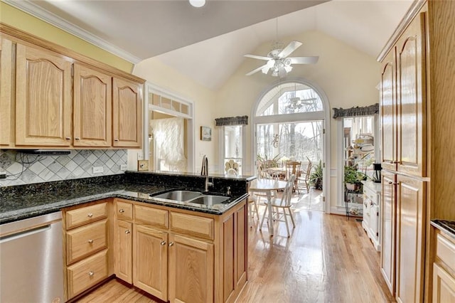 kitchen featuring a peninsula, a sink, dishwasher, light brown cabinetry, and light wood finished floors