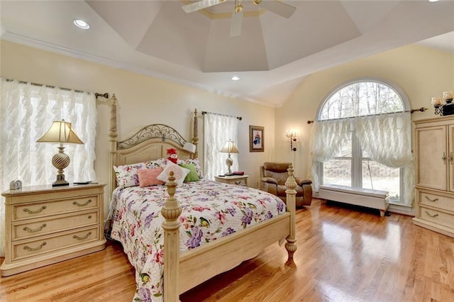 bedroom featuring ornamental molding, multiple windows, and light wood-type flooring