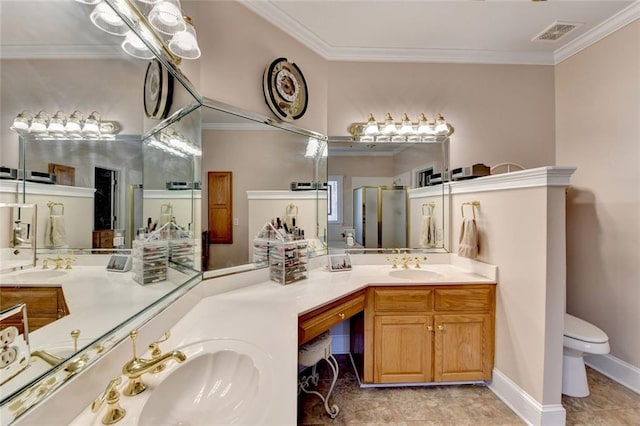 bathroom featuring crown molding, a sink, and toilet