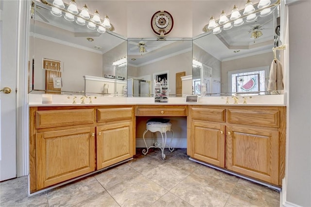 bathroom with a ceiling fan, a raised ceiling, crown molding, and vanity