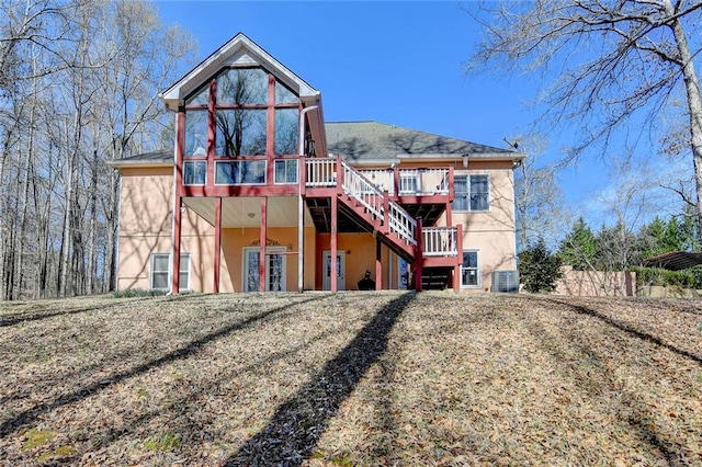 back of house with a deck, stairway, and stucco siding