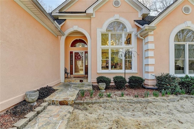 entrance to property with stucco siding