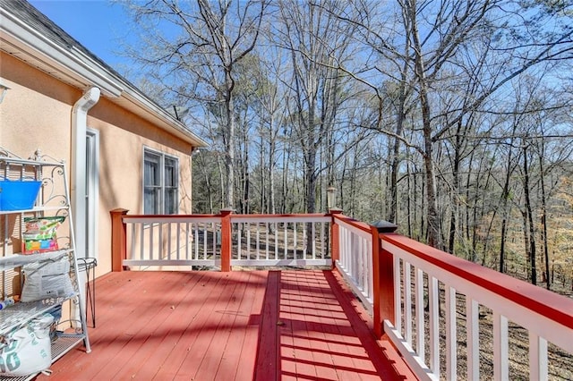 wooden deck featuring a view of trees