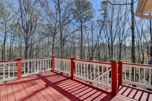 wooden deck with a forest view