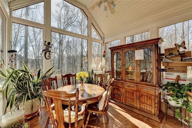 sunroom / solarium with vaulted ceiling, ceiling fan, and plenty of natural light