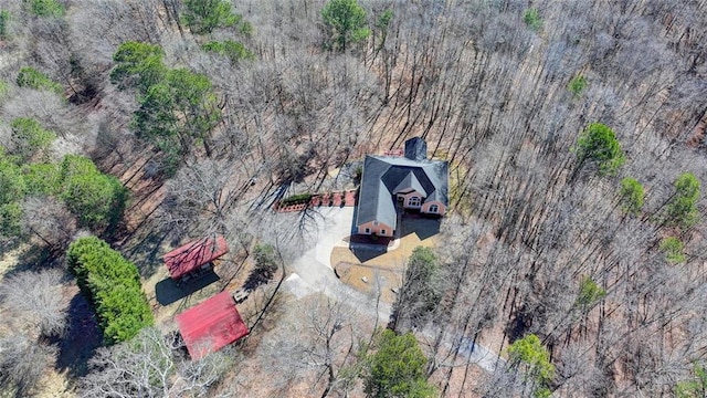 birds eye view of property featuring a view of trees