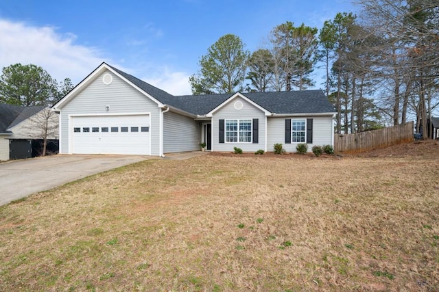 ranch-style home with concrete driveway, roof with shingles, an attached garage, fence, and a front yard