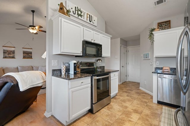 kitchen featuring visible vents, white cabinets, lofted ceiling, open floor plan, and stainless steel appliances