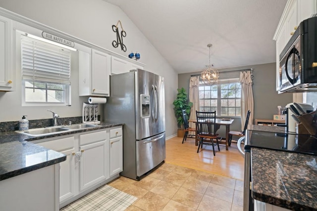 kitchen featuring white cabinetry, vaulted ceiling, a sink, black microwave, and stainless steel fridge with ice dispenser