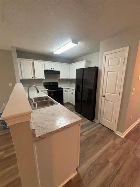 kitchen featuring kitchen peninsula, a textured ceiling, sink, black appliances, and white cabinets