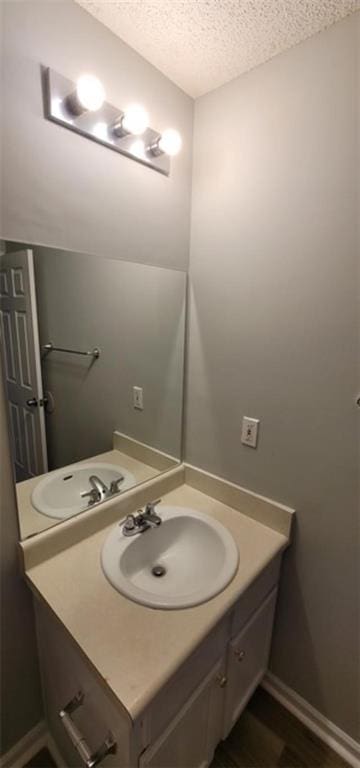 bathroom featuring vanity and a textured ceiling