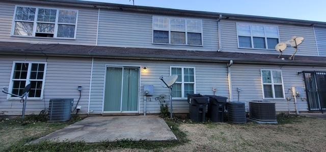 rear view of house featuring central air condition unit and a patio