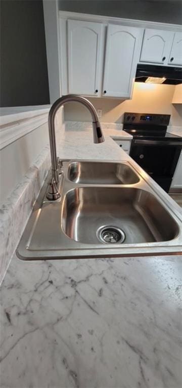 details with white cabinets, electric range, and sink