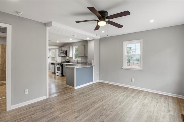 2309 Carver Dr NW, Atlanta, GA 30314 - unfurnished living room featuring light wood finished floors, ceiling fan, baseboards, and recessed lighting