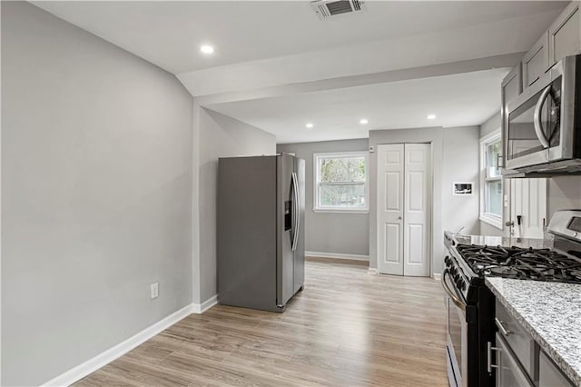 2309 Carver Dr NW, Atlanta, GA 30314 - kitchen with appliances with stainless steel finishes, light wood-style flooring, baseboards, light stone counters, and recessed lighting